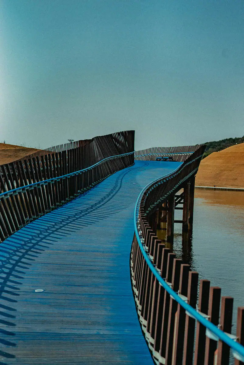 A blue wooden jetty on still water — Suncheon Bay National Garden