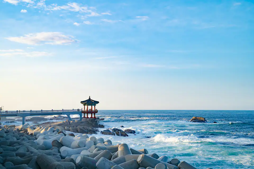 A lighthouse on the rocks at sunrise — Gangneung coast
