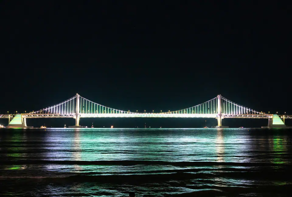 Gwangan Bridge lit up over the bay at night — Gwangalli Beach, Busan