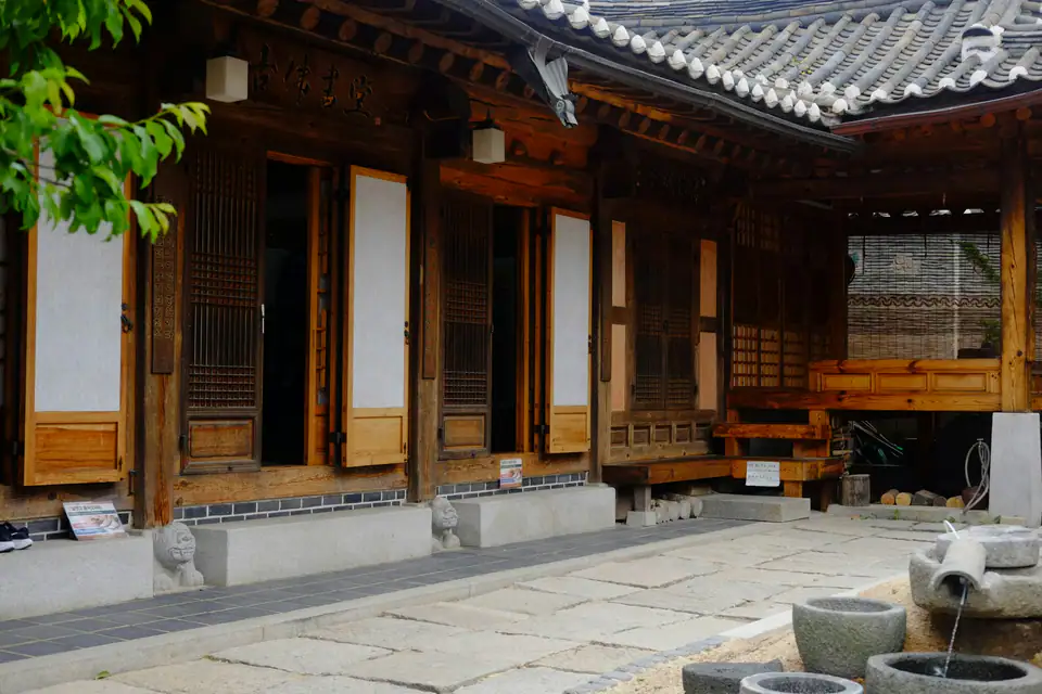 A wooden hanok around a stone courtyard — Hanok courtyard, Seoul